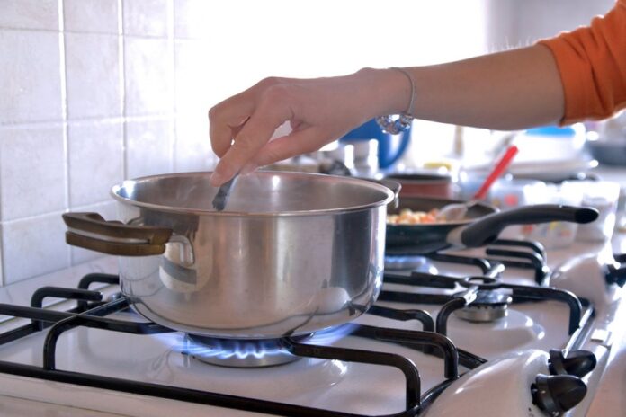 iStock-654750700-goodbye-to-gas-stoves-cooking-on-gas-burner